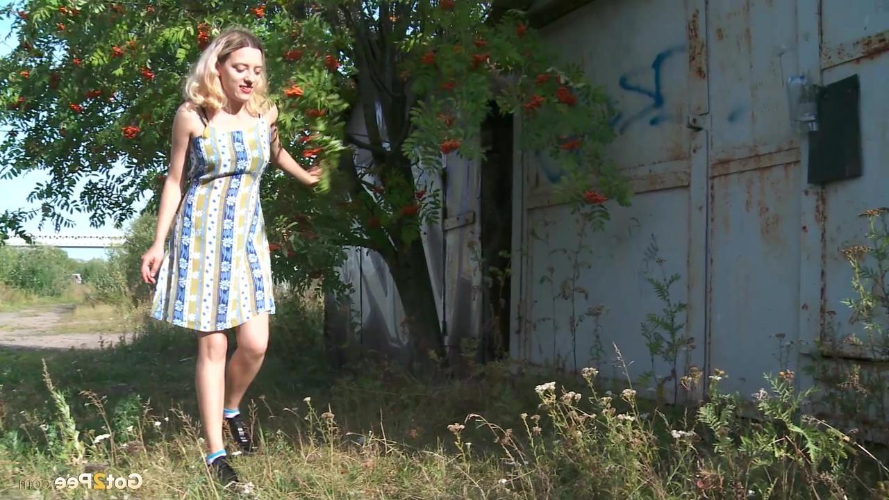 15P Caucasian girl Sasha pulls down her underwear to pee behind a building