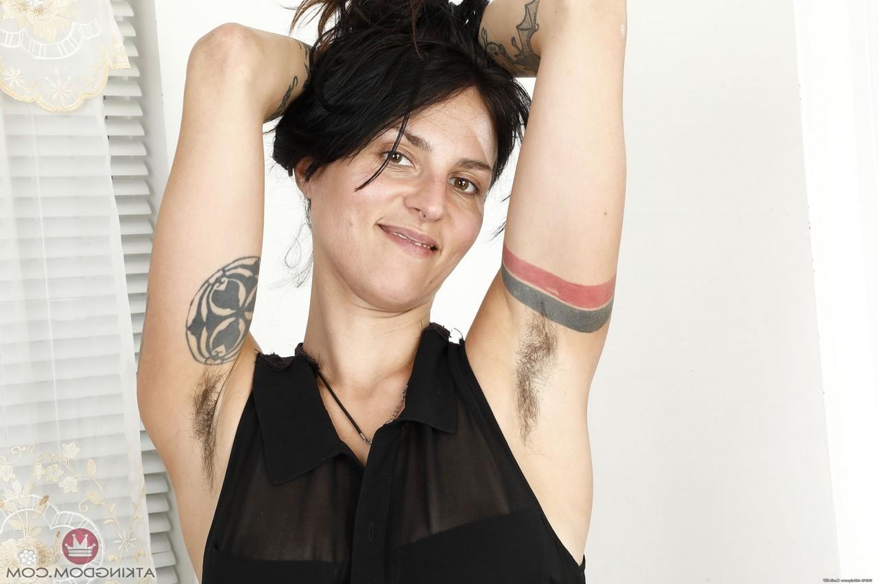 20P Caucasian babe with tattoos Delta Hauser displays her bushy twat in a solo