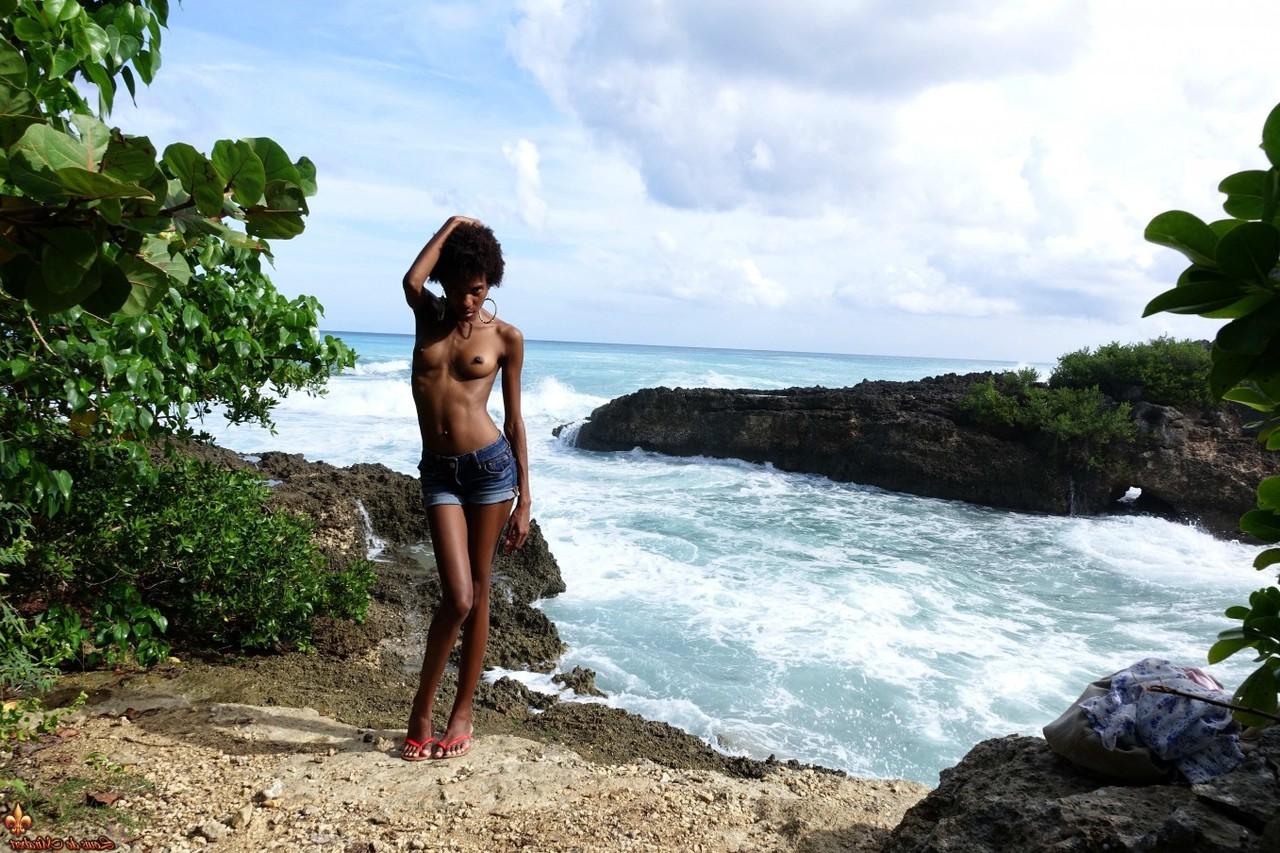 16P Ebony chick goes topless near the ocean in cut off shorts