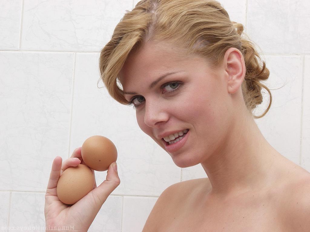 14P Naked girl with a landing strip pussy cracks a brown egg while taking a shower