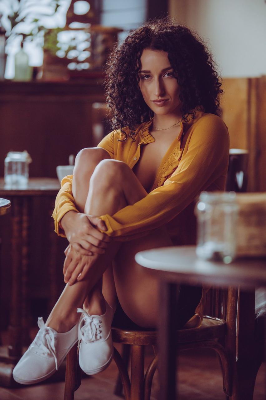 10P Curly haired babe Luca Miklosi strips as she drinks her morning coffee