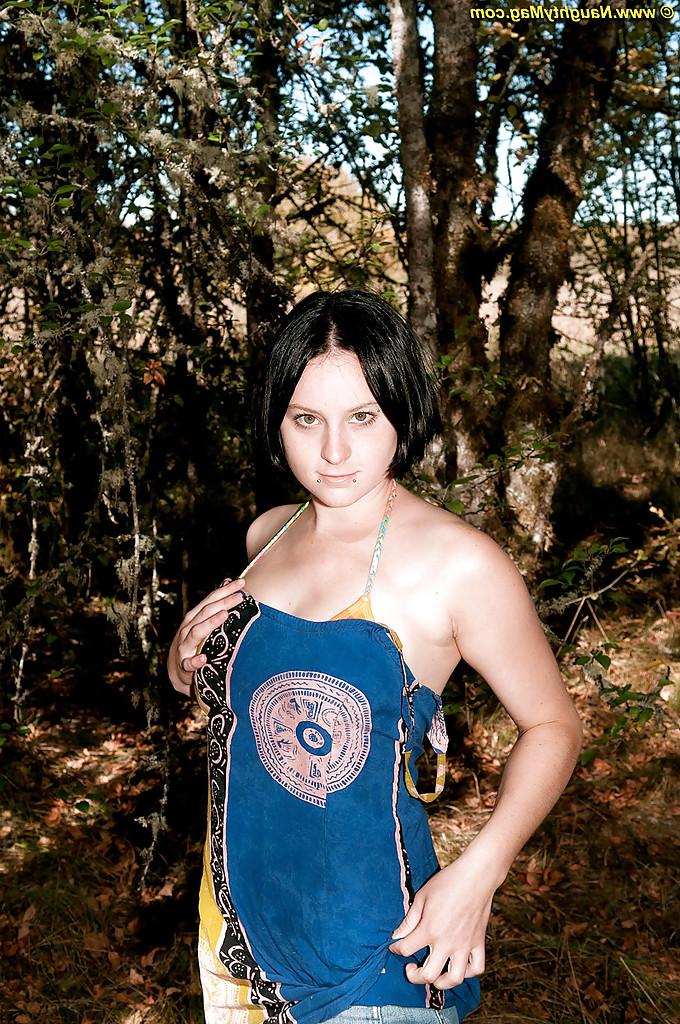 16P Une ado brune aux gros seins se met nue et se touche dans la forêt.
