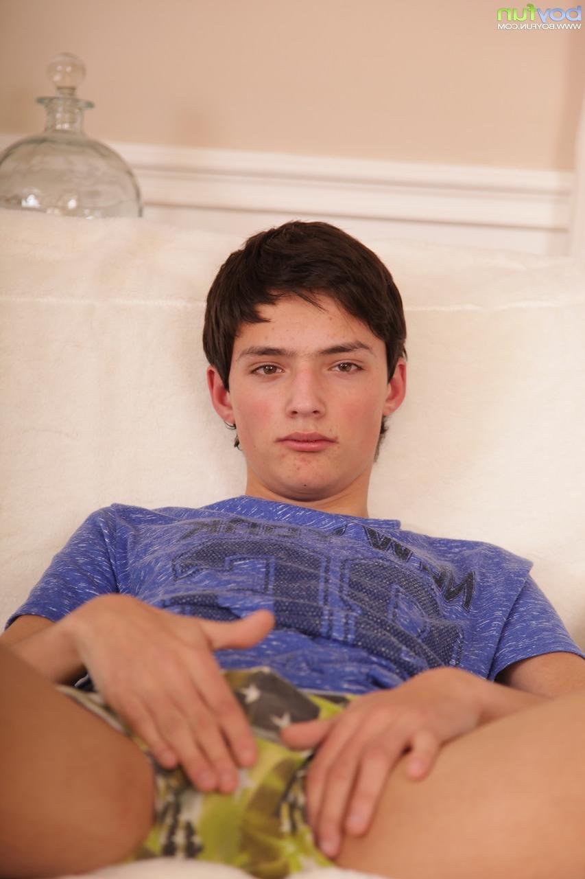 20P Cute brunette twink Jake Vosnik doffs his pants and undies and pumps his dick