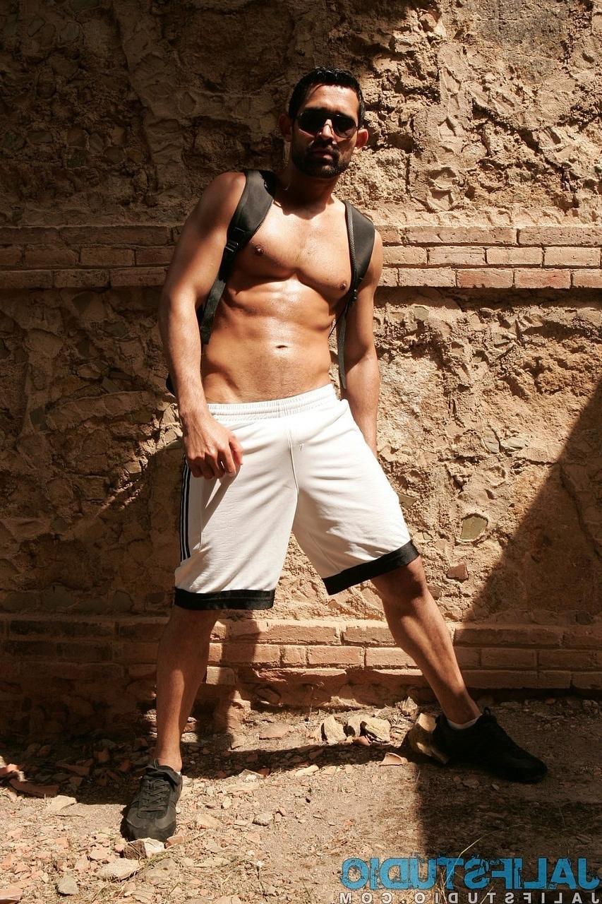 20P Dark-haired gay model Billy Baval posing naked and pissing outdoors