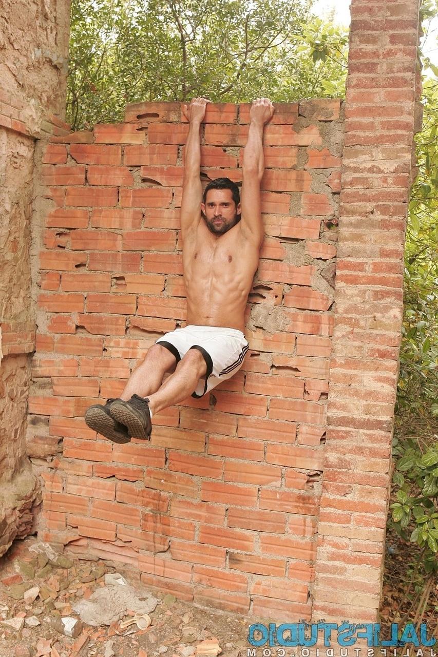 20P Dark-haired gay model Billy Baval posing naked and pissing outdoors