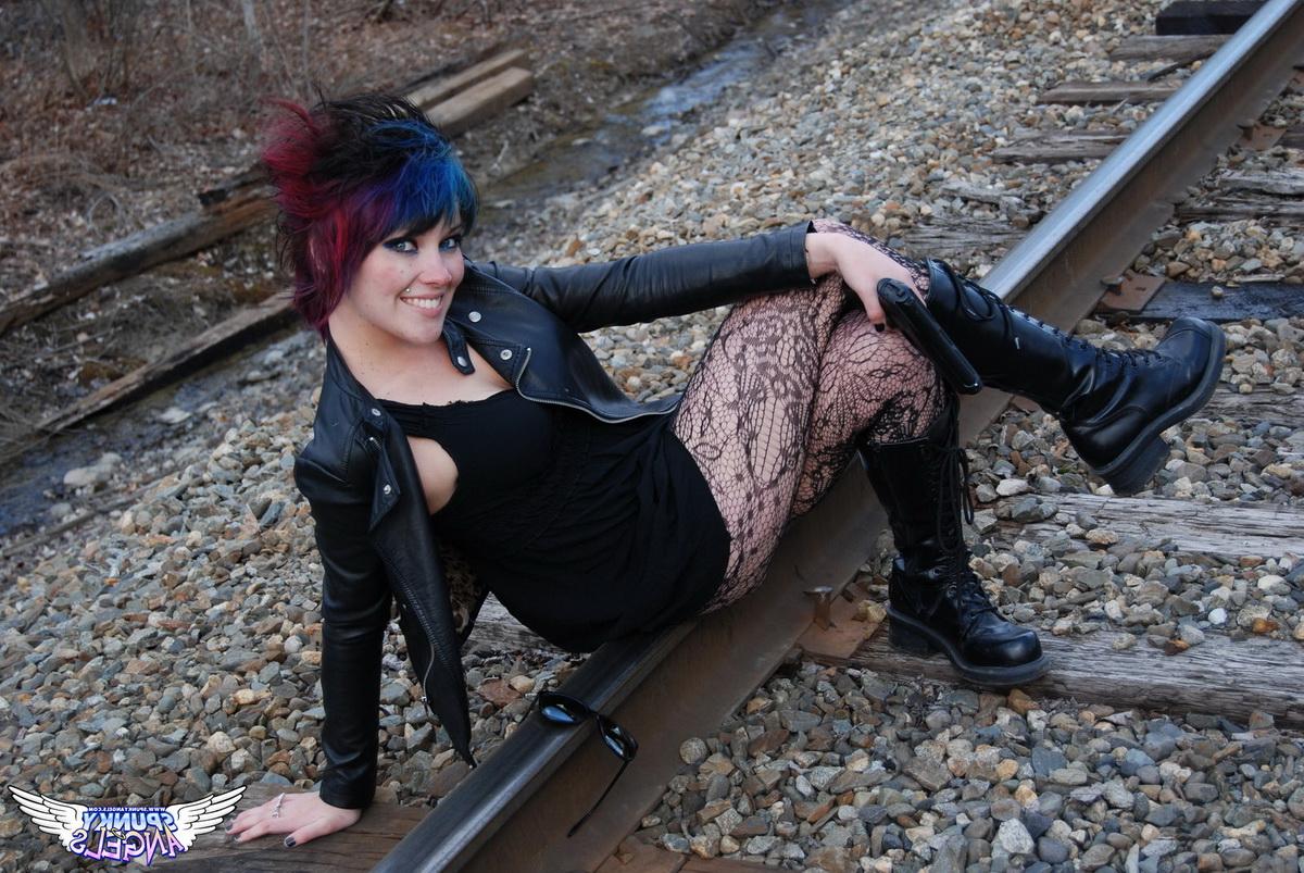 12P Punk girl Sabrina poses for an upskirt solo shoot on railway tracks