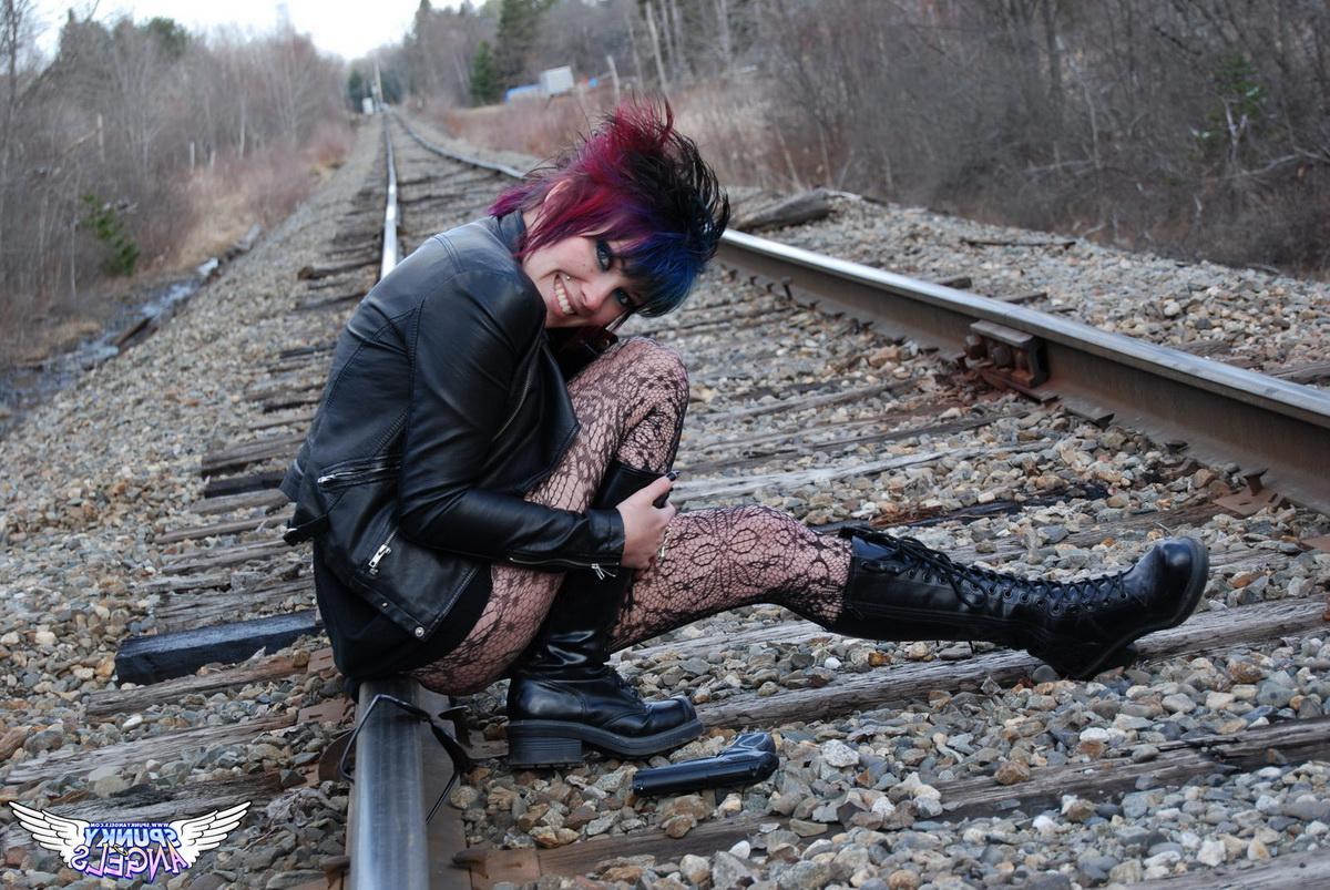 12P Punk girl Sabrina poses for an upskirt solo shoot on railway tracks