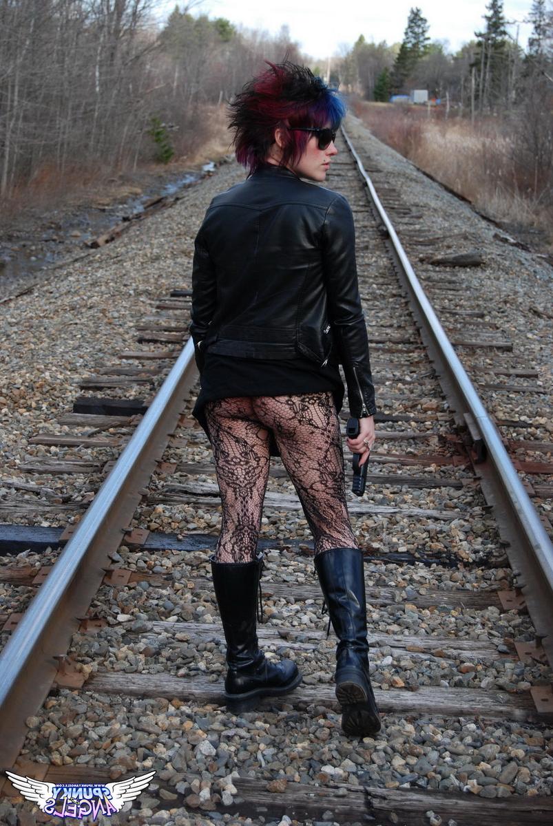 12P Punk girl Sabrina poses for an upskirt solo shoot on railway tracks