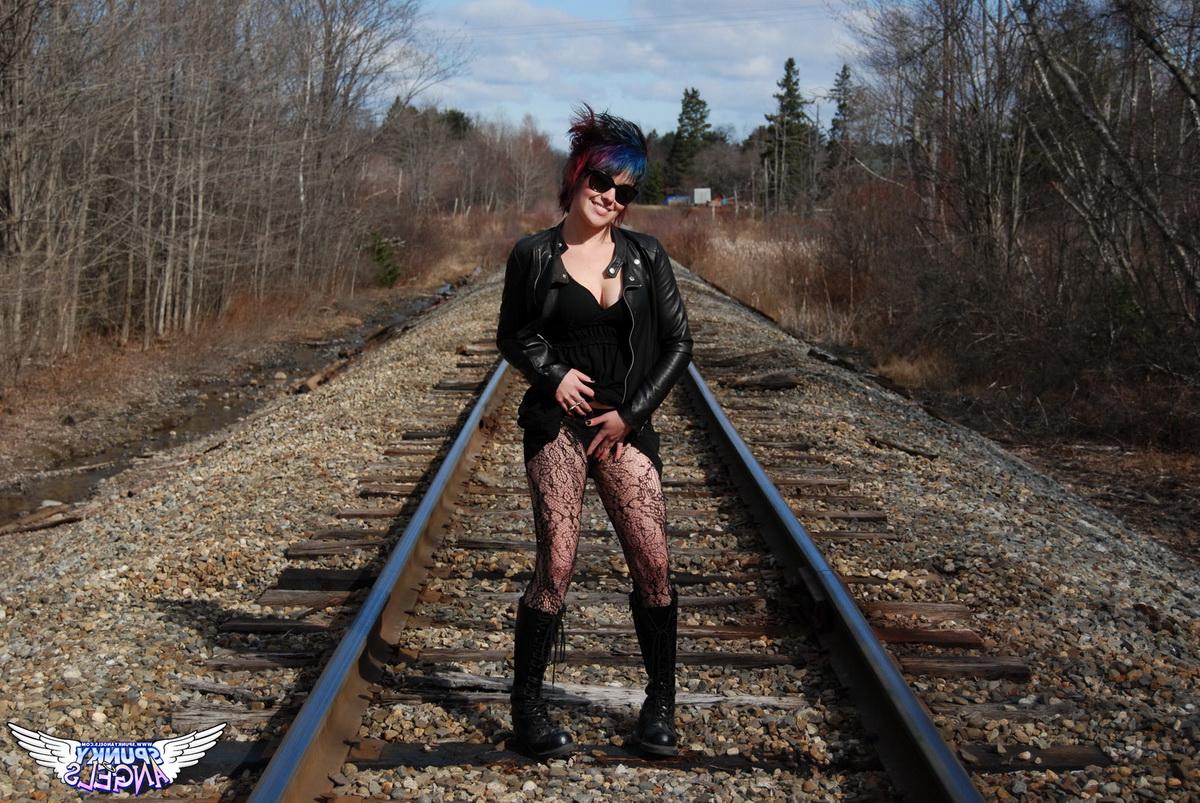 12P Punk girl Sabrina poses for an upskirt solo shoot on railway tracks