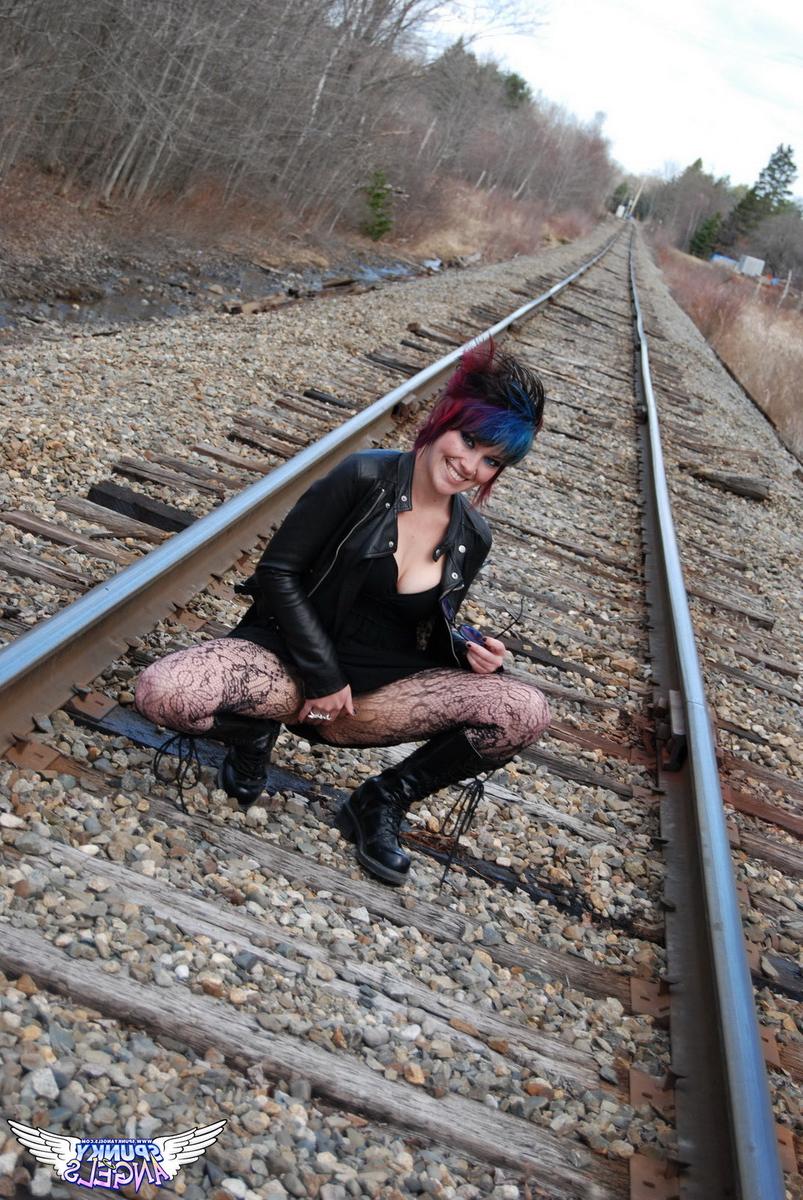 12P Punk girl Sabrina poses for an upskirt solo shoot on railway tracks