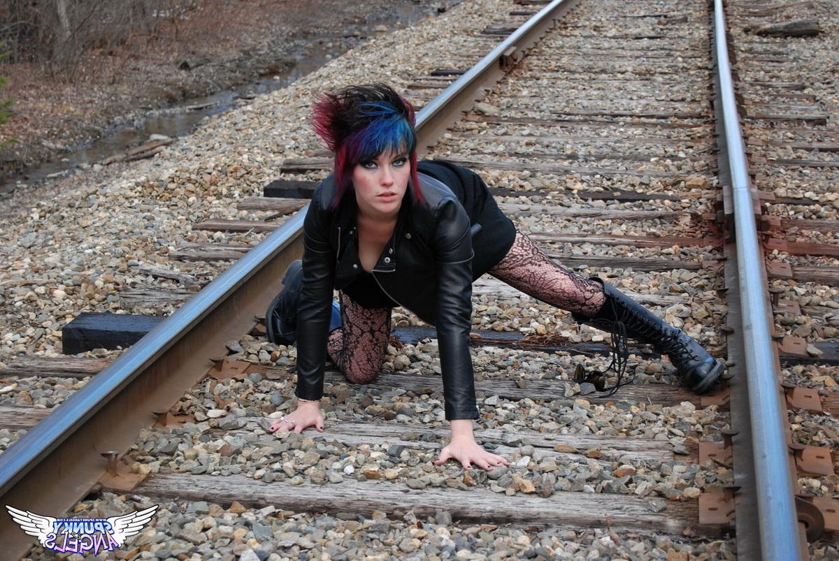 12P Punk girl Sabrina poses for an upskirt solo shoot on railway tracks