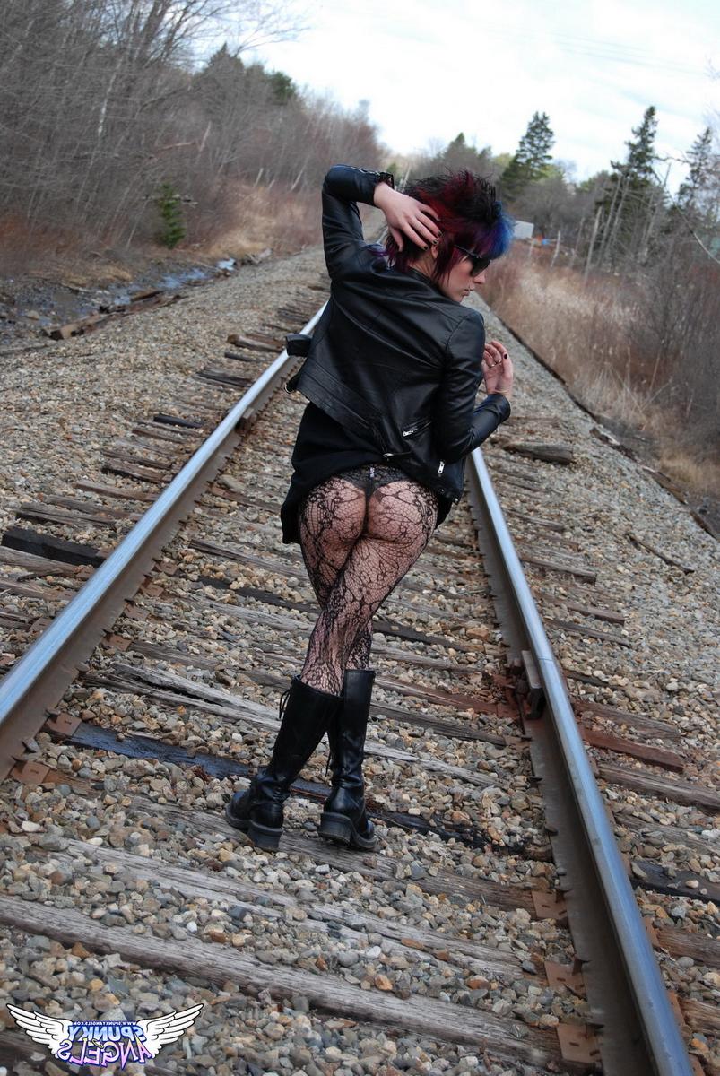 12P Punk girl Sabrina poses for an upskirt solo shoot on railway tracks