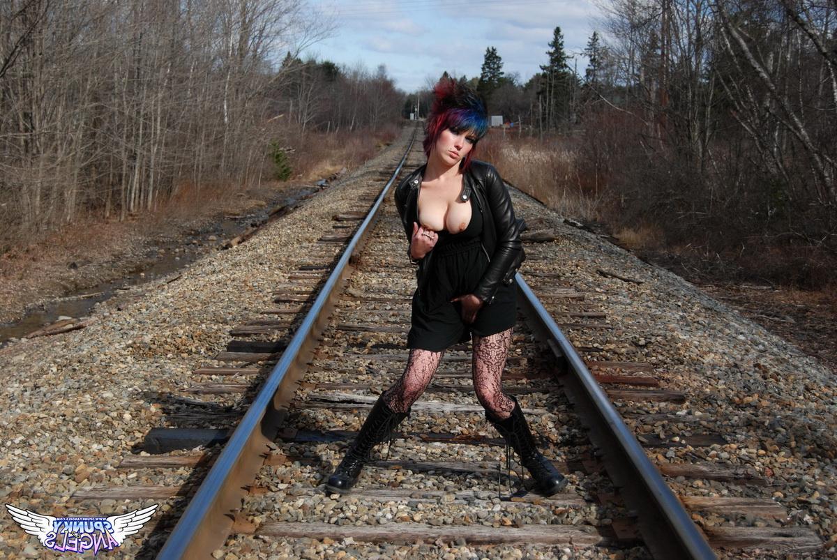 12P Punk girl Sabrina poses for an upskirt solo shoot on railway tracks