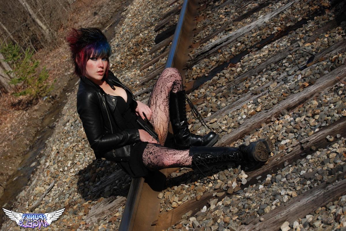 12P Punk girl Sabrina poses for an upskirt solo shoot on railway tracks