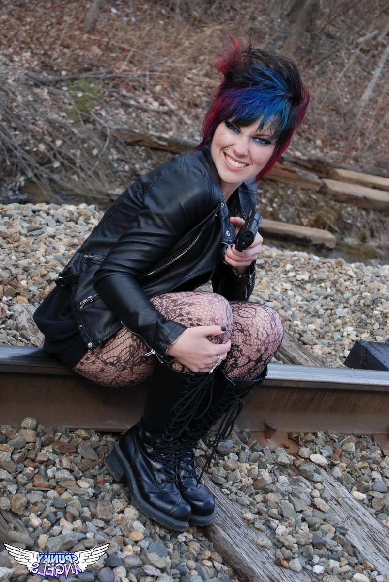12P Punk girl Sabrina poses for an upskirt solo shoot on railway tracks