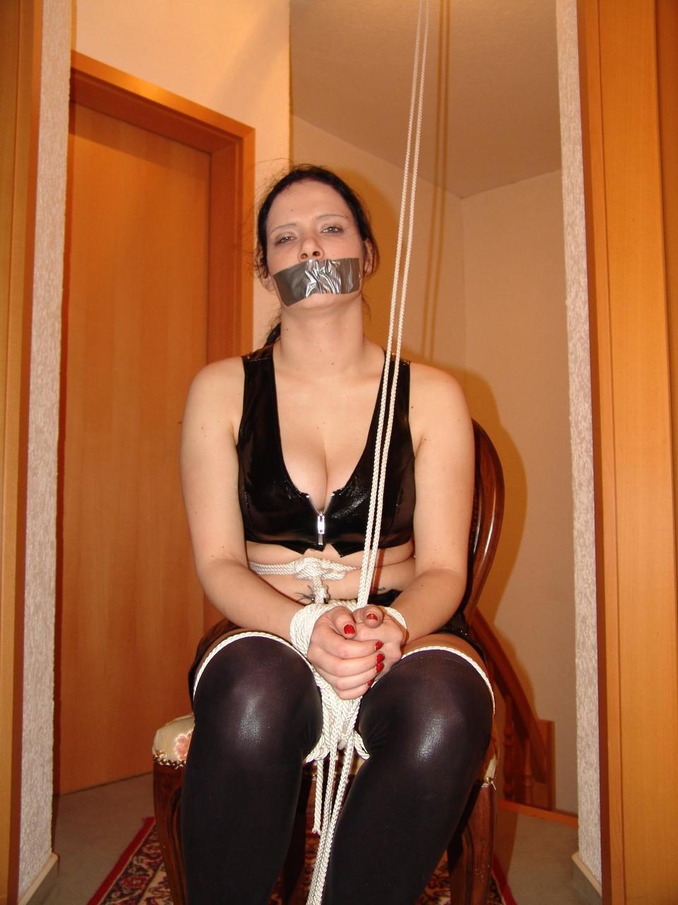 16P An unhappy looking brunette is silenced with duct tape while tied up with rope