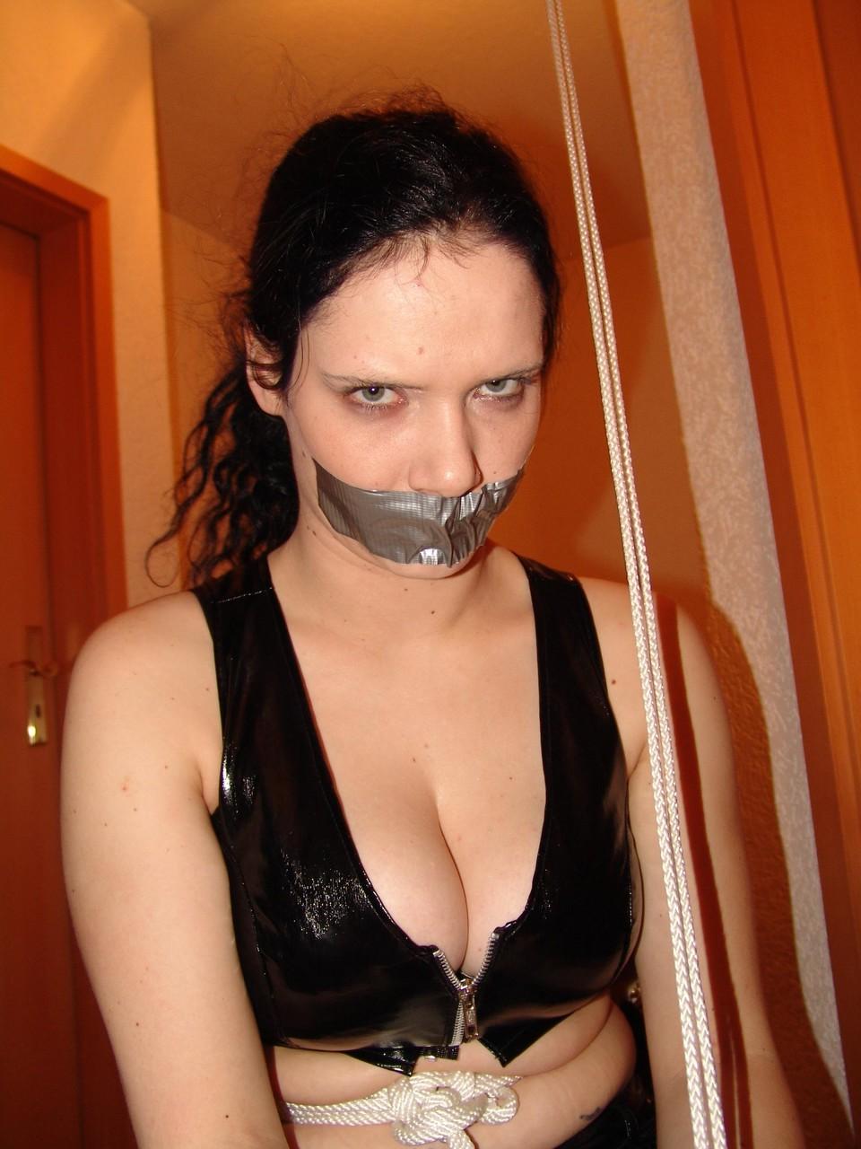 16P An unhappy looking brunette is silenced with duct tape while tied up with rope