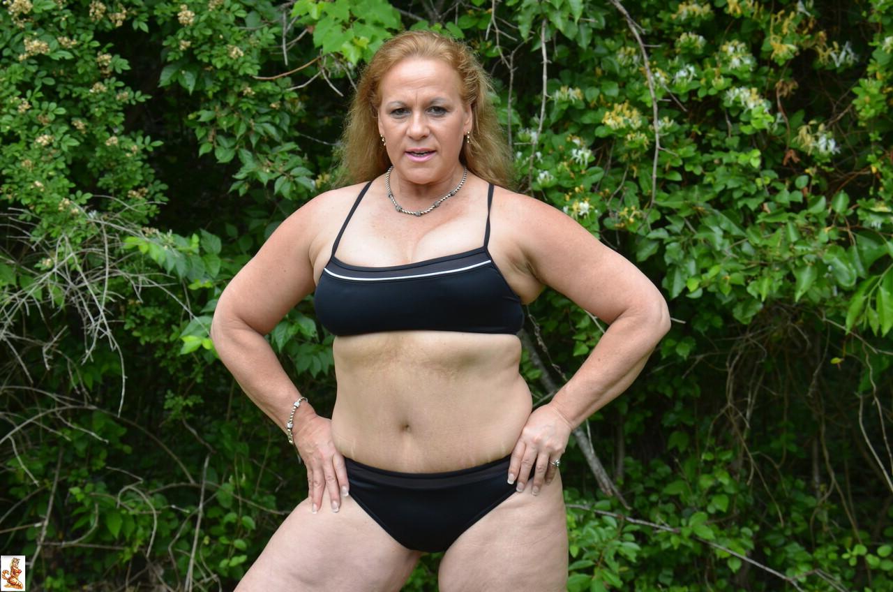 15P Mature bodybuilder Stunning Summer shows off her strong body outdoors