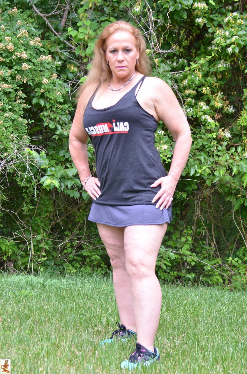 15P Mature bodybuilder Stunning Summer shows off her strong body outdoors