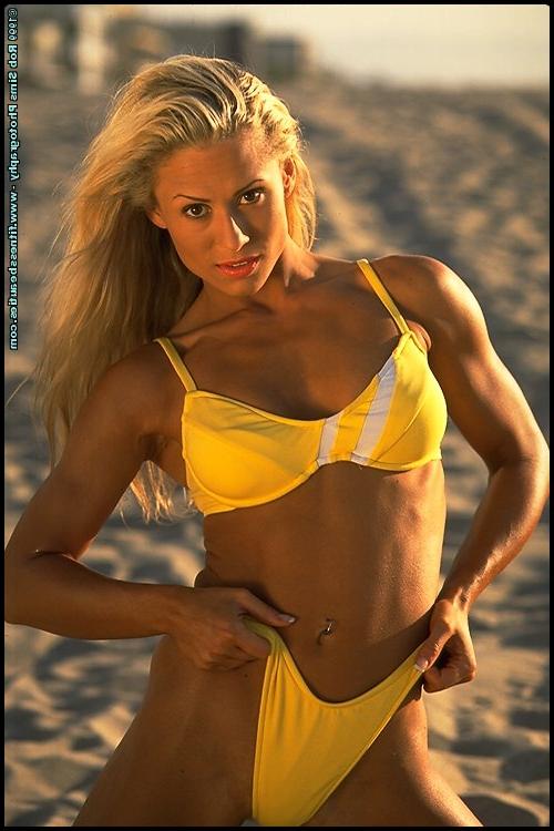 15P Fitness model Sarah Orbanic and a girlfriend pose on on a beach in bikinis