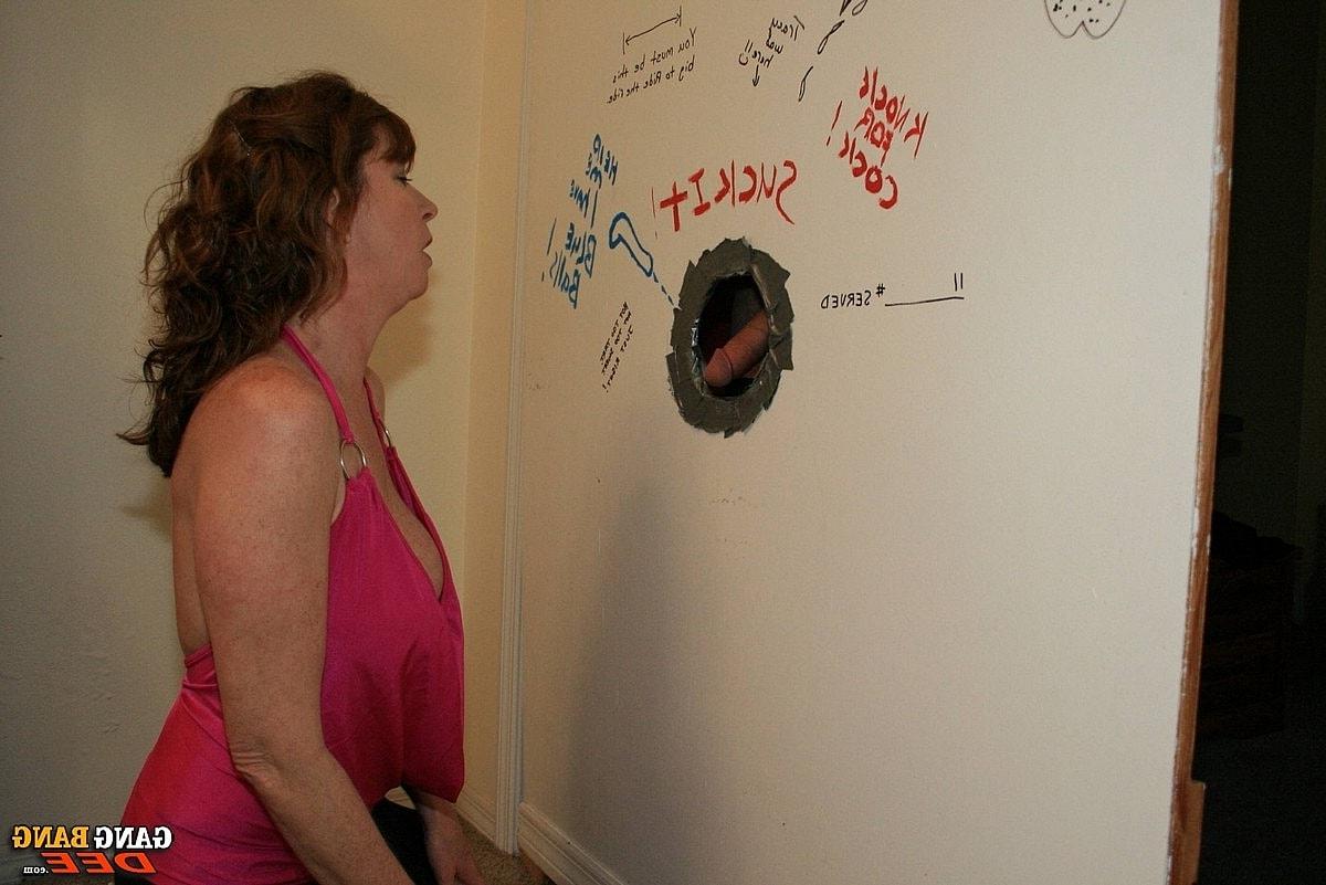 14P Middle-aged redhead Dee Delmar gives a blowjob at a gloryhole