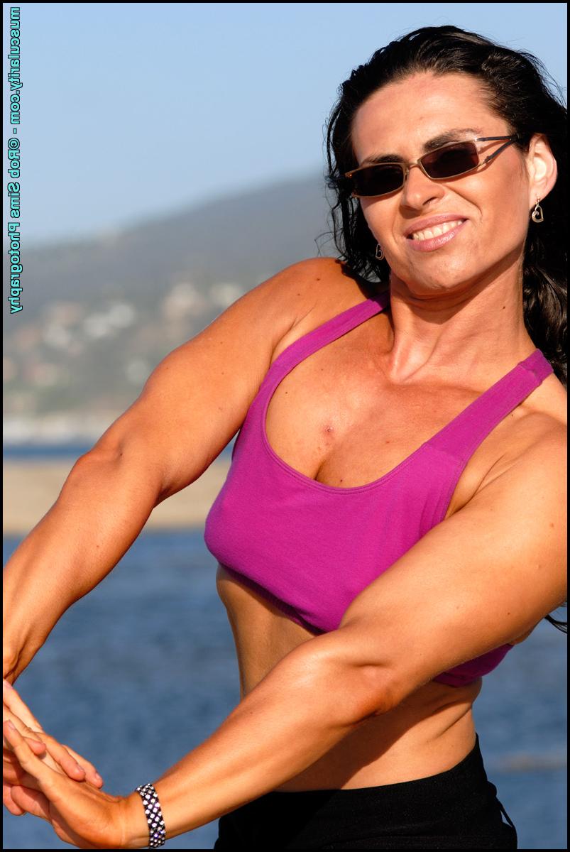 15P Brunette bodybuilder Lada Phihalova flexes on a beach while wearing sunglasses