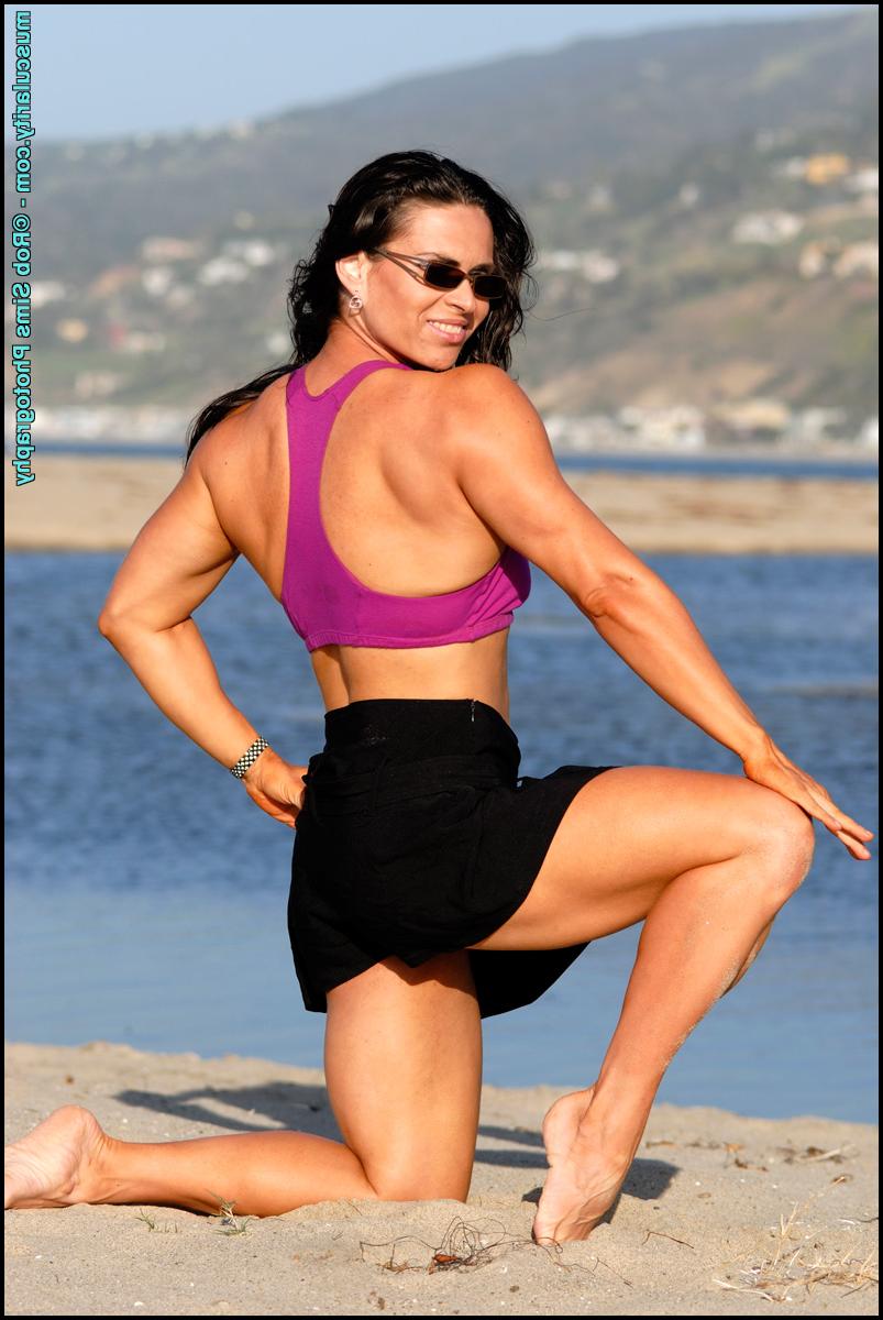 15P Brunette bodybuilder Lada Phihalova flexes on a beach while wearing sunglasses