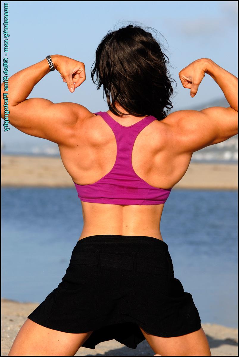 15P Brunette bodybuilder Lada Phihalova flexes on a beach while wearing sunglasses