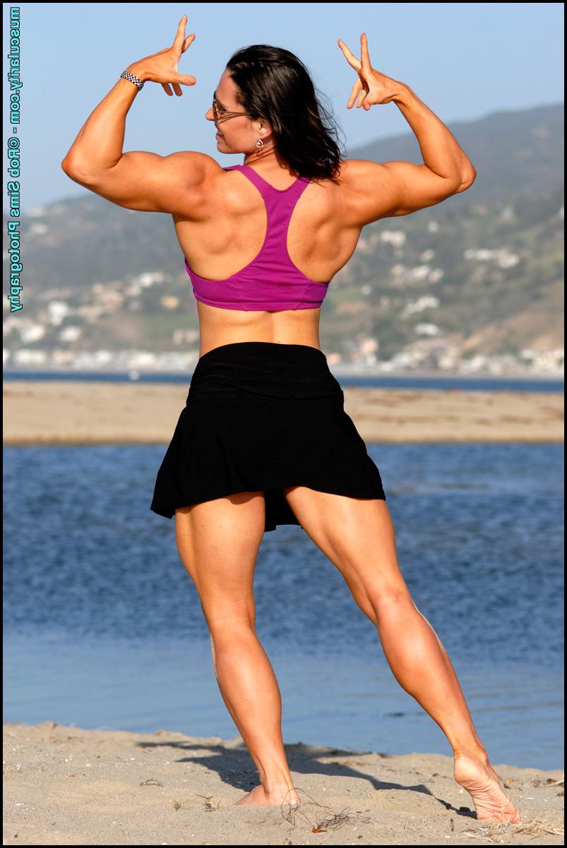 15P Brunette bodybuilder Lada Phihalova flexes on a beach while wearing sunglasses