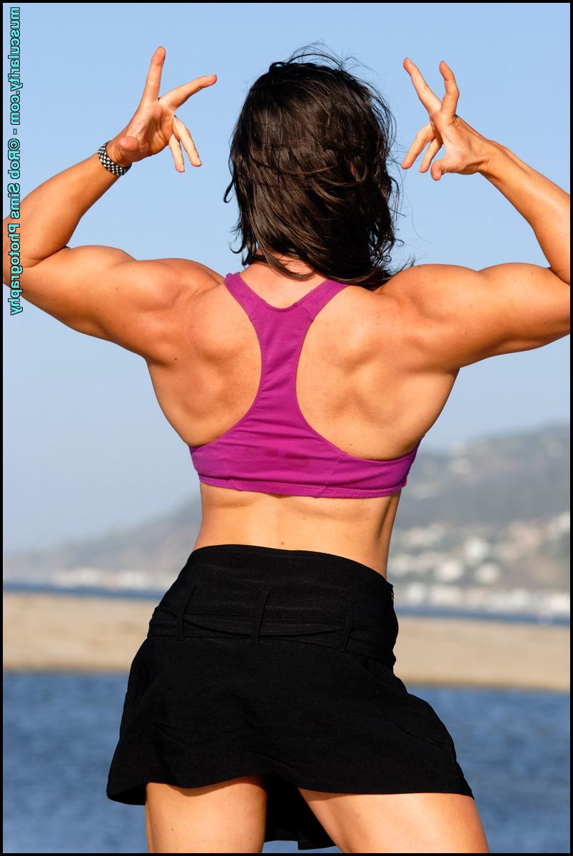 15P Brunette bodybuilder Lada Phihalova flexes on a beach while wearing sunglasses