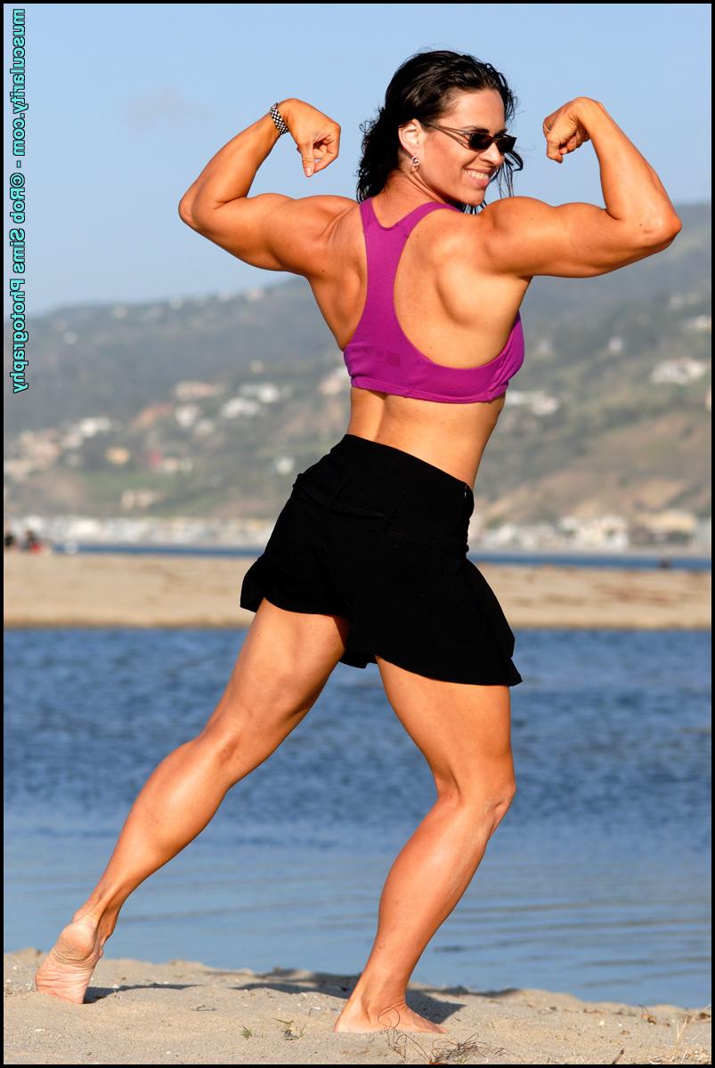 15P Brunette bodybuilder Lada Phihalova flexes on a beach while wearing sunglasses