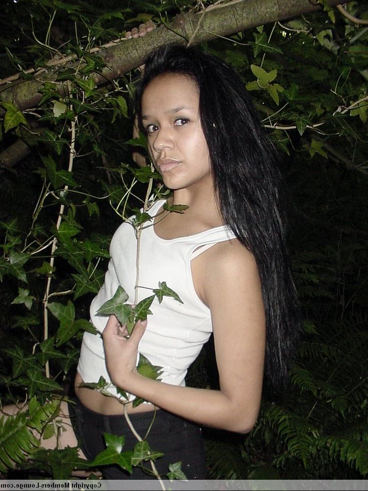18P Pretty Indian girl hangs from a tree limb in a tank top and shorts