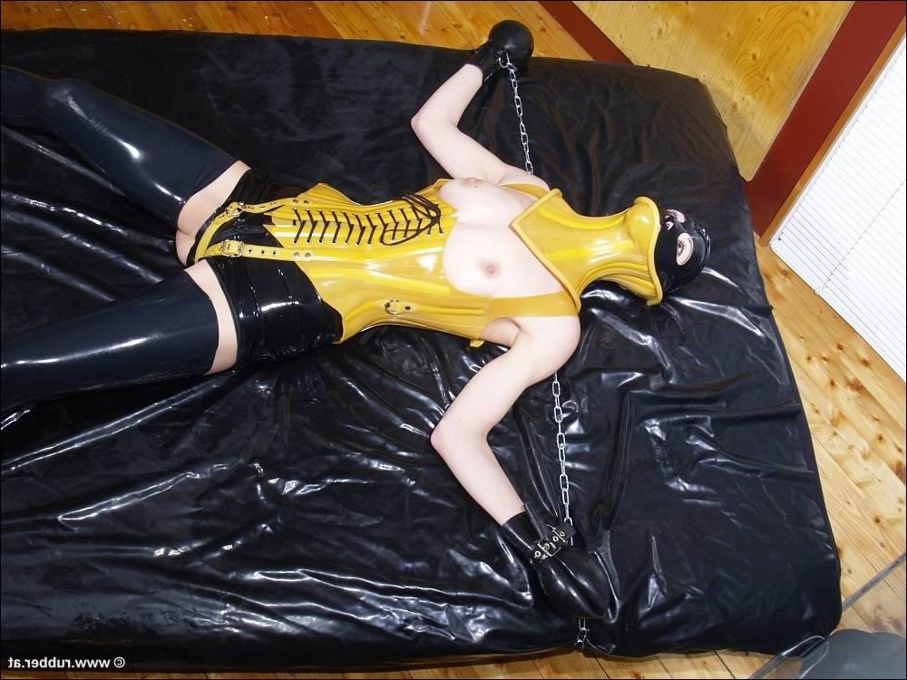 16P Dark-haired girl is restrained and masturbated in latex before posing alone