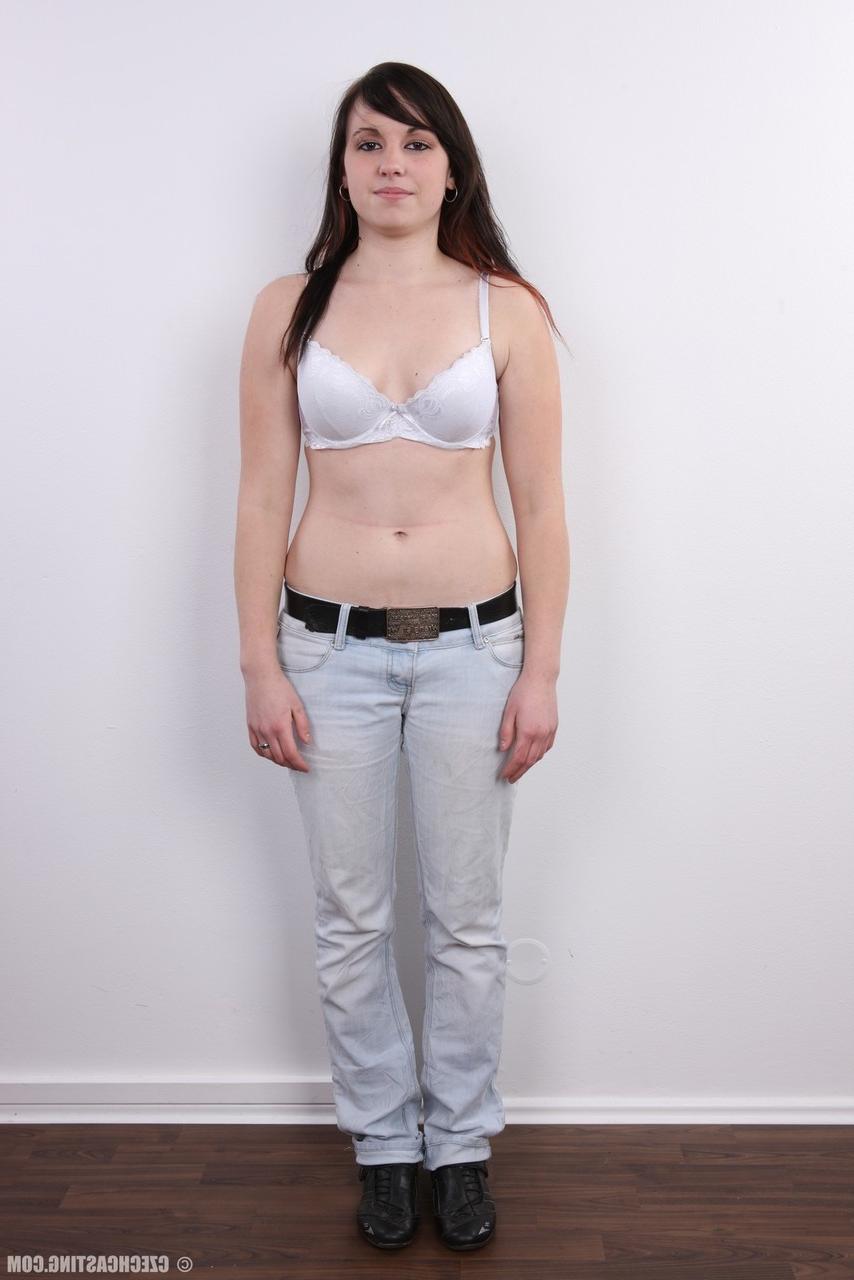 20P Amateur model with black hair stands totally naked after removing her clothes