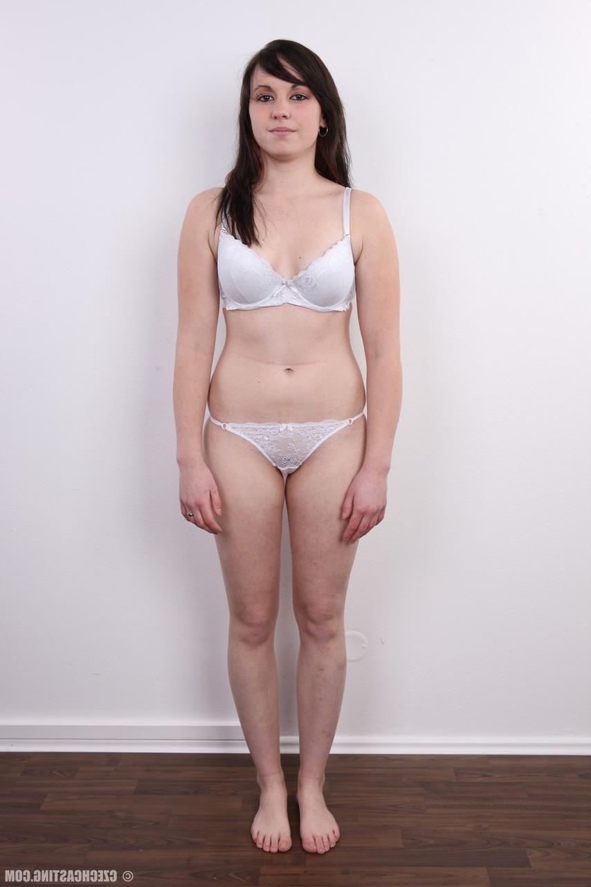 20P Amateur model with black hair stands totally naked after removing her clothes