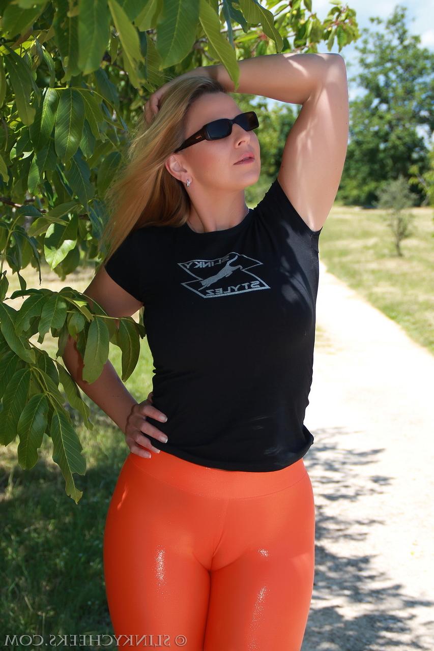 15P Curvy MILF in orange tights Desyra Noir shows her juicy bum outdoors