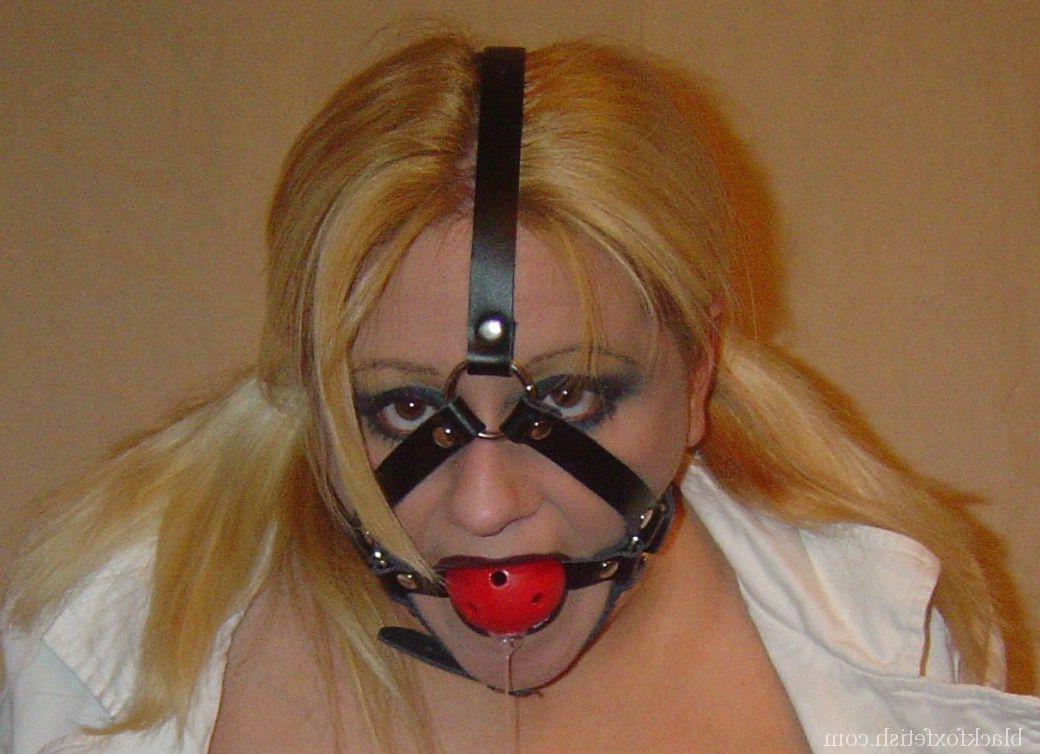 16P Blonde chick is silenced with a ball gag while showing her breasts
