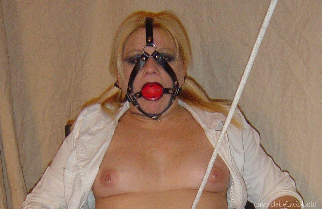 16P Blonde chick is silenced with a ball gag while showing her breasts