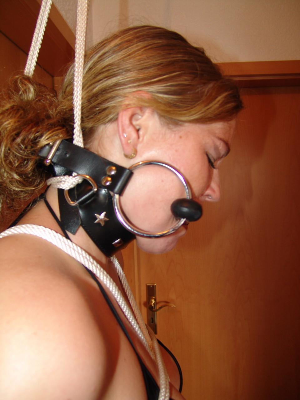 16P Natural redhead is bound and gagged in a latex bikini and matching boots