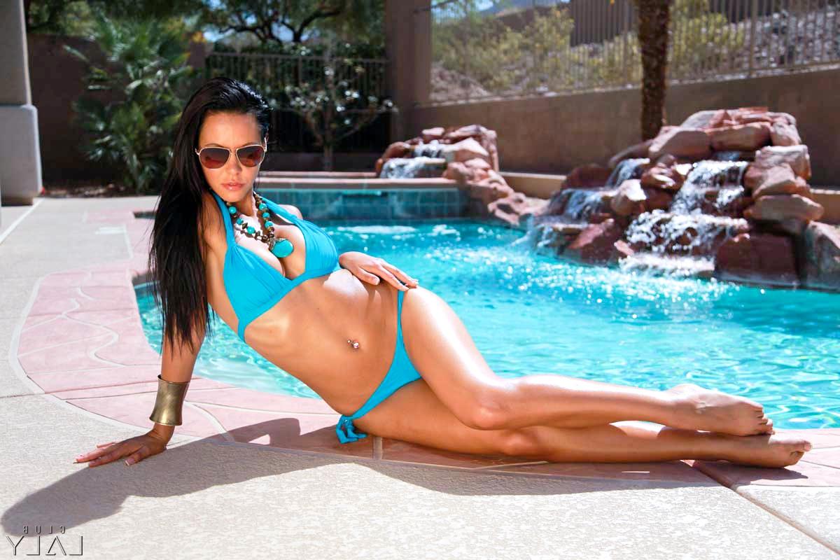15P Laly Vallade, une chaude latina, se met nue au bord d'une piscine avec des lunettes de soleil.