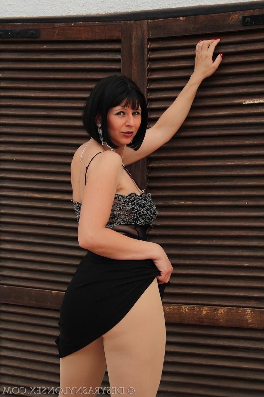 15P Mature dark-haired Desyra Noir shows her big tits & poses in pantyhose