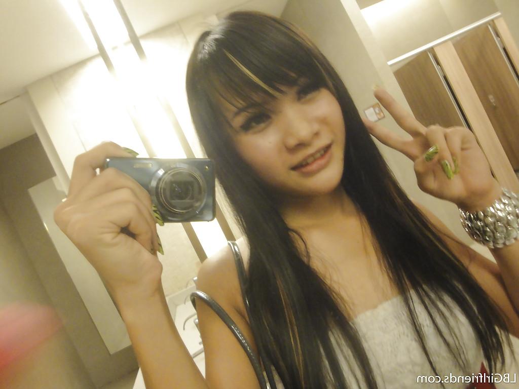 16P Cute skinny Asian tranny Mon posing outdoors and showing her cock