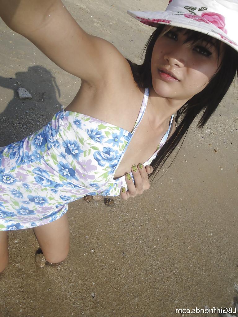 16P Cute skinny Asian tranny Mon posing outdoors and showing her cock