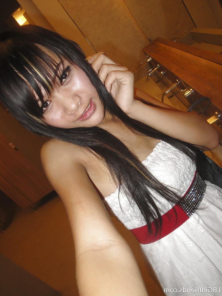 16P Cute skinny Asian tranny Mon posing outdoors and showing her cock