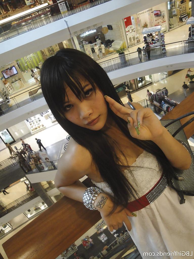 16P Cute skinny Asian tranny Mon posing outdoors and showing her cock