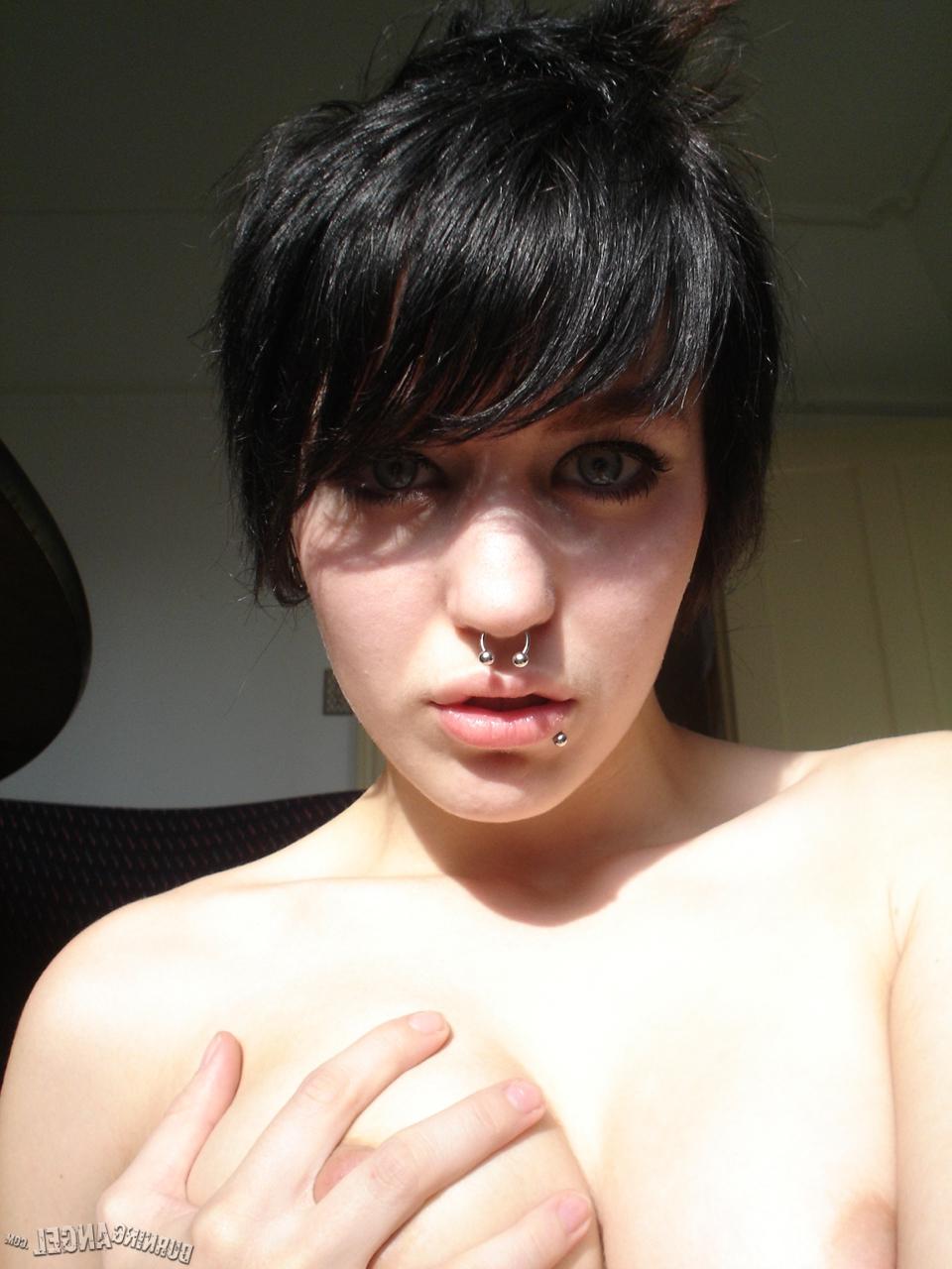 16P Short-haired punk chick with pierced nose, lip, navel in her own photos