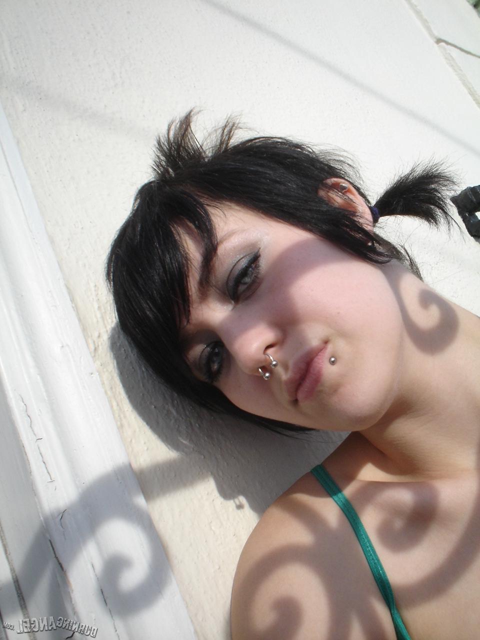 16P Short-haired punk chick with pierced nose, lip, navel in her own photos