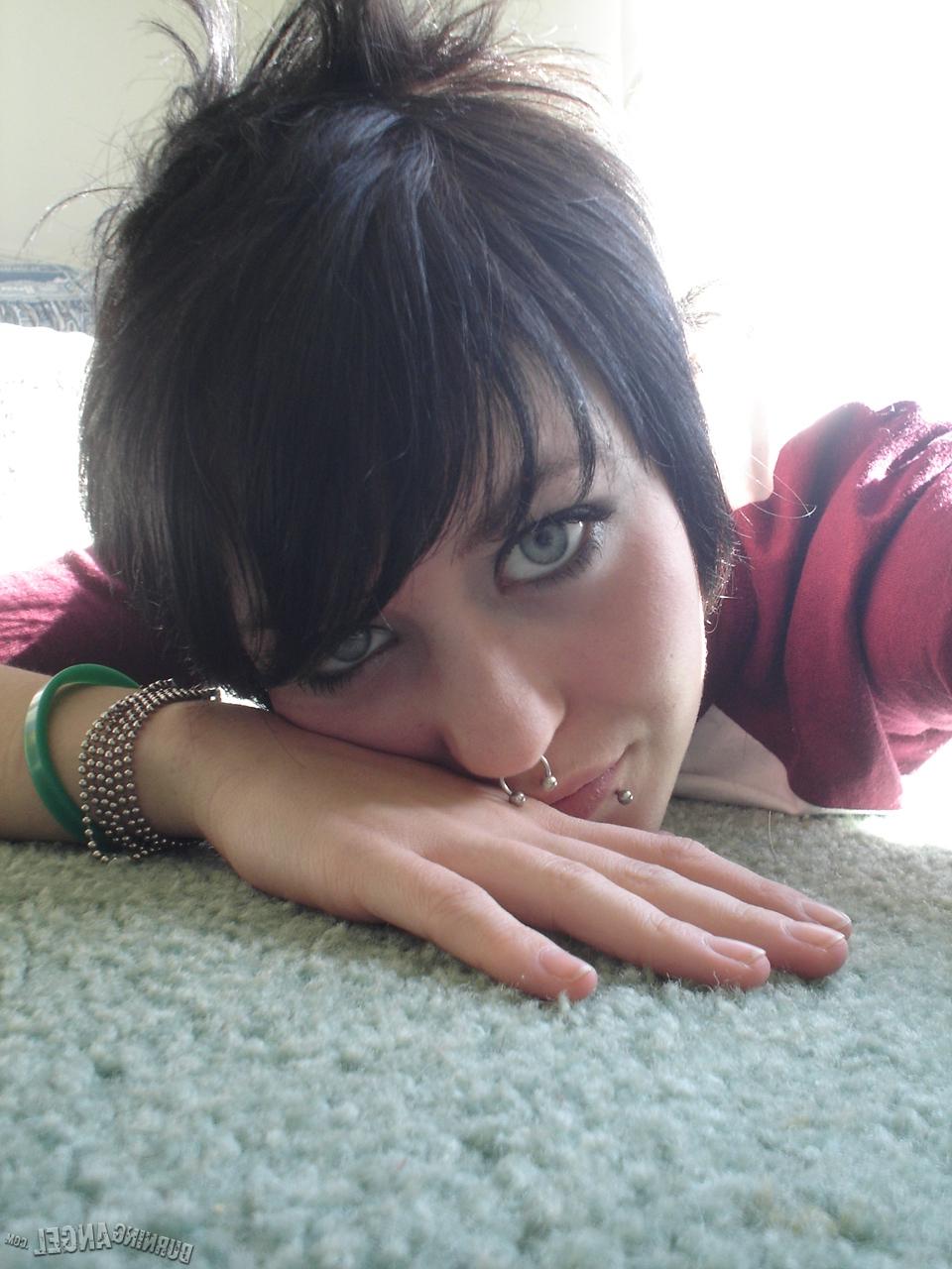 16P Short-haired punk chick with pierced nose, lip, navel in her own photos