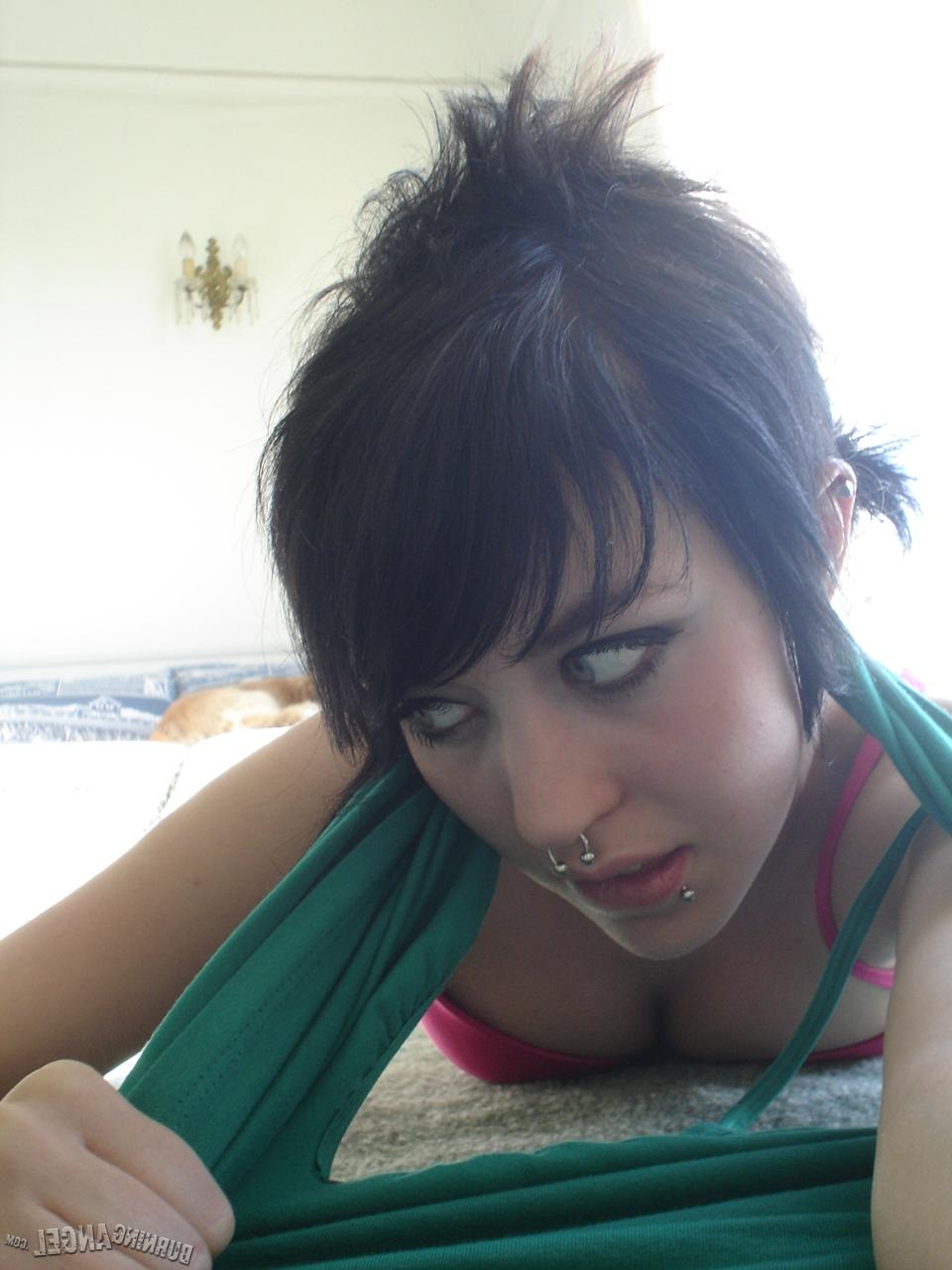 16P Short-haired punk chick with pierced nose, lip, navel in her own photos
