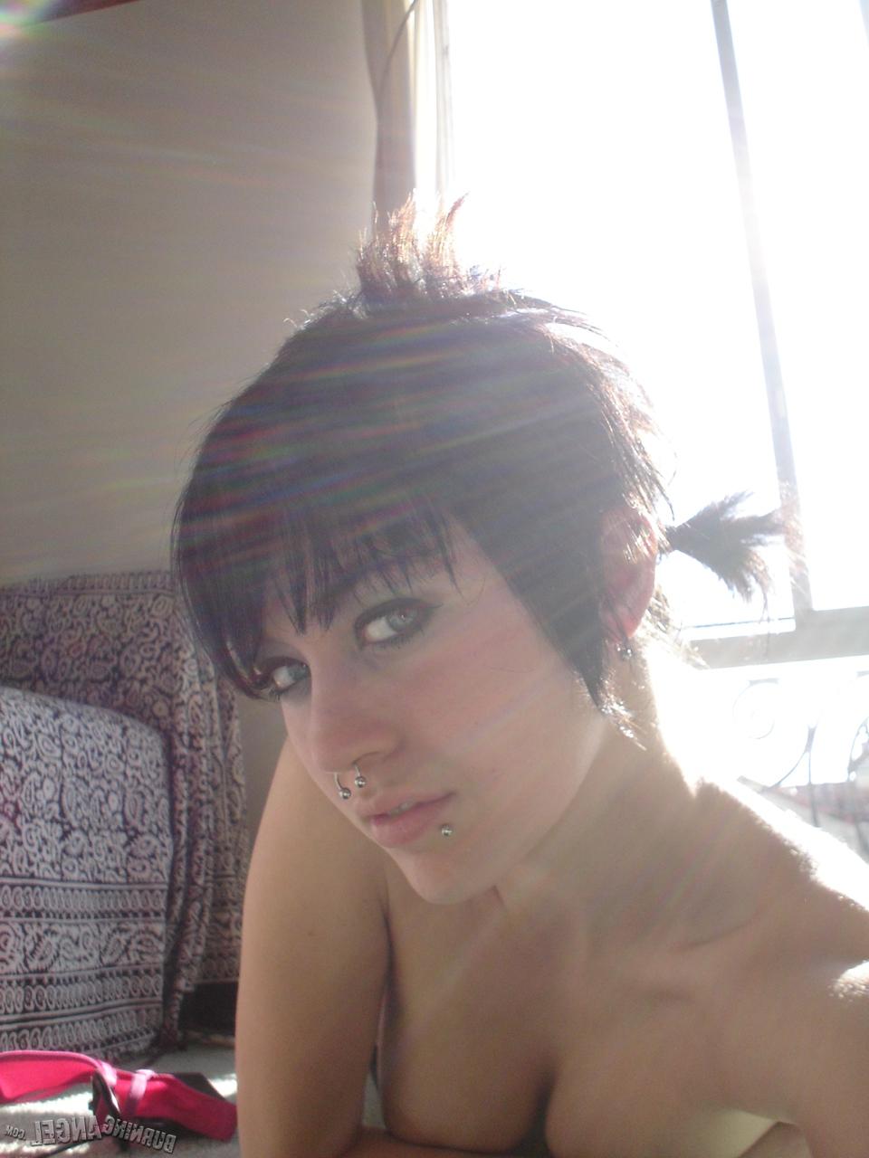 16P Short-haired punk chick with pierced nose, lip, navel in her own photos
